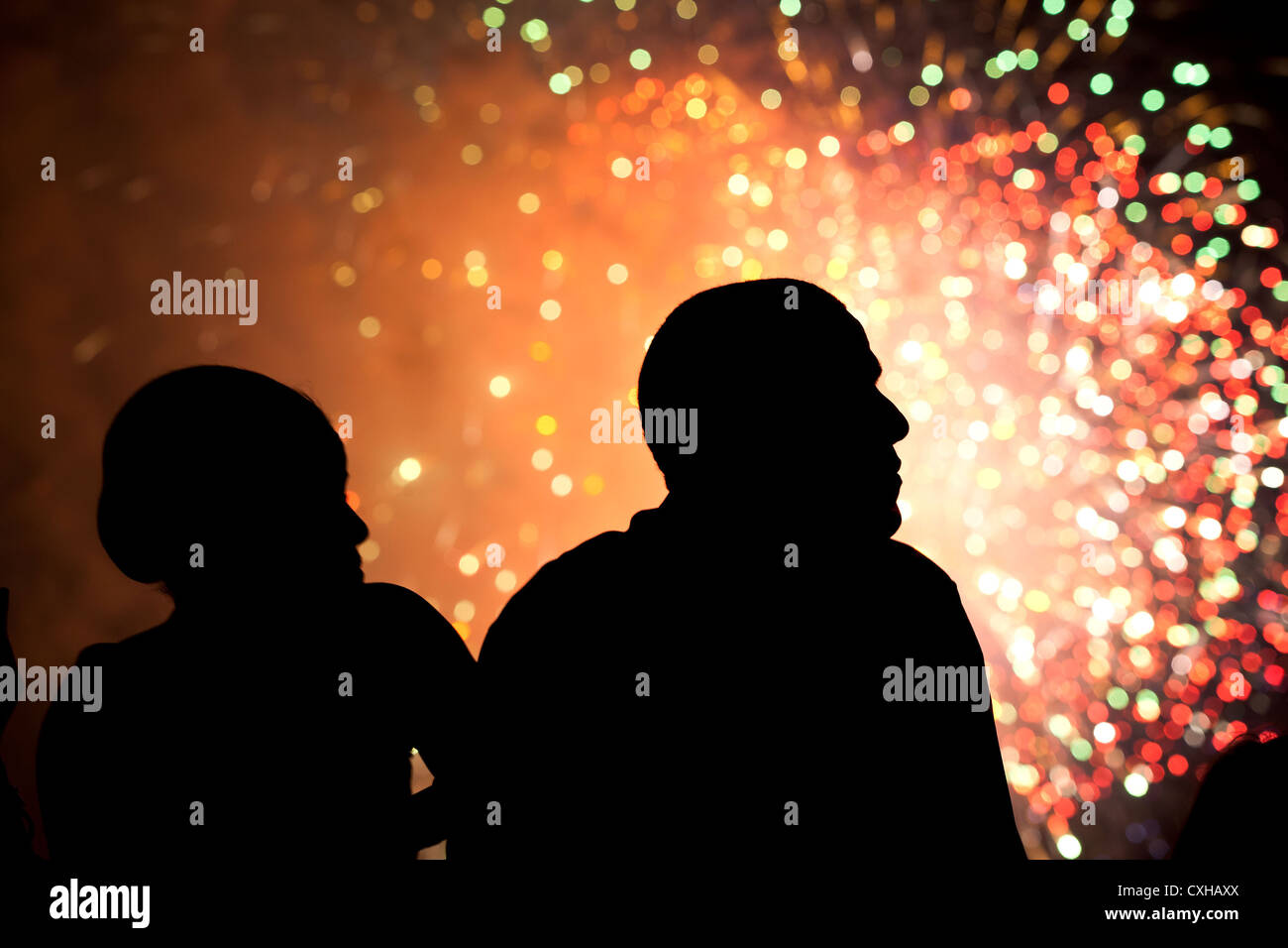 US President Barack Obama and First Lady Michelle Obama watch fireworks July 4, 2011 from the roof of the White House. Stock Photo