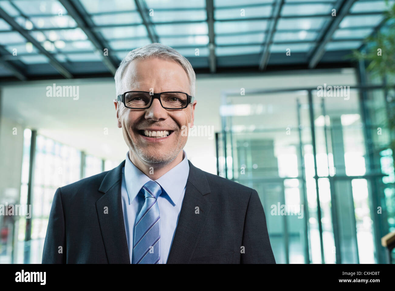 Germany, Stuttgart, Businessman smiling, portrait Stock Photo