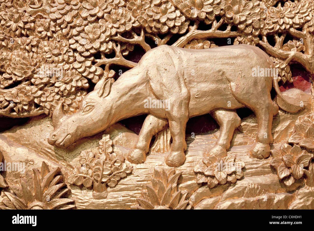 Carved rhino detail of ornate door into Viharn, Wat Mahawan, Chiang Mai, Thailand Stock Photo