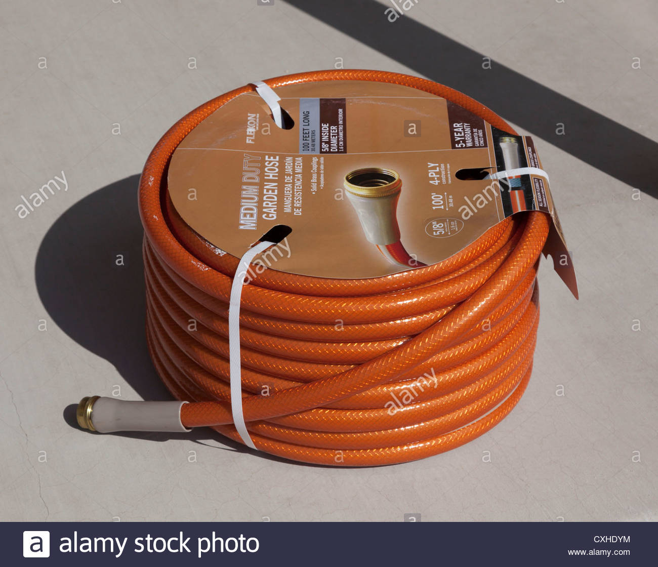 New 100 Foot Roll Of Garden Hose Copper Colored On Concrete Label