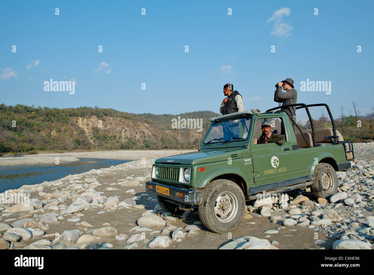 Tourist spotting wildlife on the bank of Ramganga river in Jim Corbett Tiger Reserve, India. Stock Photo