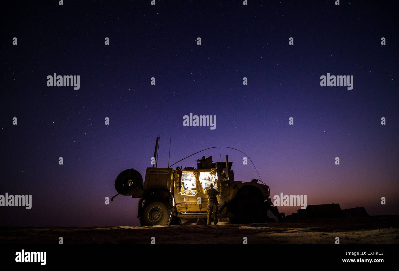 U.S. Air Force 1st Lt. Drew Parks, Joint Terminal Attack Controller, 82nd Expeditionary Air Support Operations Squadron, grabs equipment from a Mine-Resistant, Ambush-Protected, All-Terrain Vehicle on Sept. 11, 2012, Southwest Asia. JTAC's establish and maintain command and control communications, control air traffic, naval gun fire, and provide precision terminal attack guidance of U.S. and coalition close air support. Parks hometown is Hampstead, N.C. Stock Photo