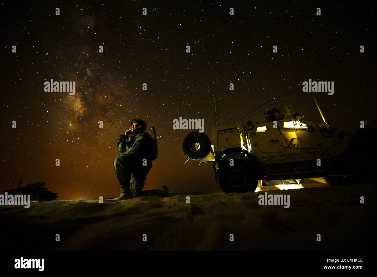 U.S. Air Force 1st Lt. Drew Parks, Joint Terminal Attack Controller, 82nd Expeditionary Air Support Operations Squadron, communicates with a U.S. Navy F/A-18 Super Hornet supporting Operation Spartan Shield on Sept. 11, 2012, Southwest Asia. JTAC's establish and maintain command and control communications, control air traffic, naval gun fire, and provide precision terminal attack guidance of U.S. and coalition close air support. Parks hometown is Hampstead, N.C. Stock Photo