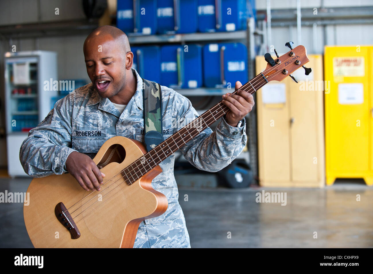 Senior Airman Henry Roberson plays the guitar during a U.S. Air Forces Central Band 'Top Flight' performance at the Transit Center at Manas, Kyrgyzstan, Sept. 22, 2012. This performance is part of a 12-day tour to develop friendships and provide entertainment to service members and the Kyrgyz Republic. Roberson is deployed from Joint Base San Antonio, Texas and a native of Detroit. Stock Photo