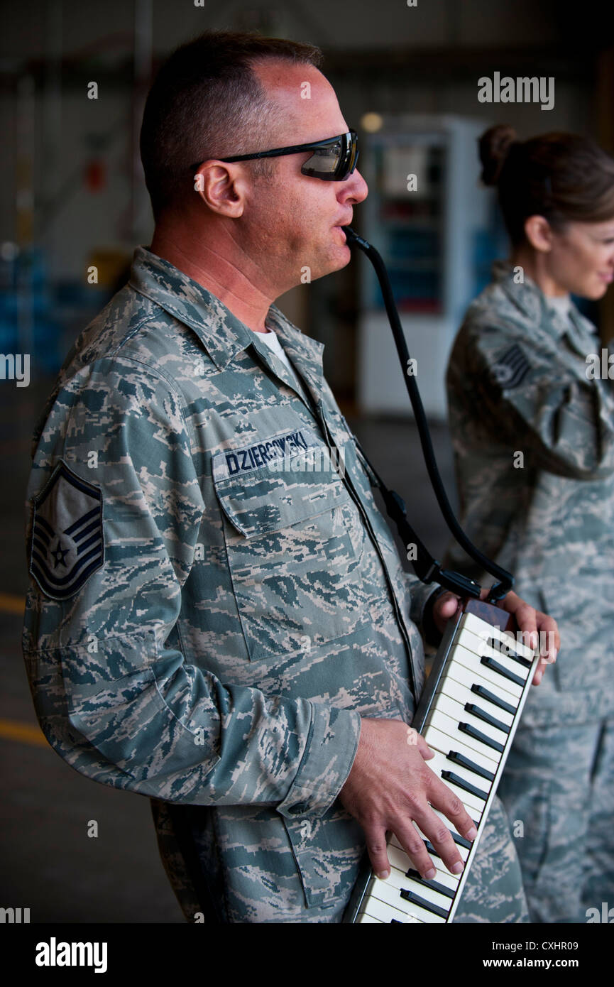 Master Sgt. Darrin Dziergowski plays the melodica keyboard during a U.S. Air Forces Central Band 'Top Flight' performance at the Transit Center at Manas, Kyrgyzstan, Sept. 22, 2012. Top Flight, a six-person band from Joint Base San Antonio, Texas, is on a 12-day tour in Kyrgyzstan. Dziergowski is a native of Suitland, Md. Stock Photo