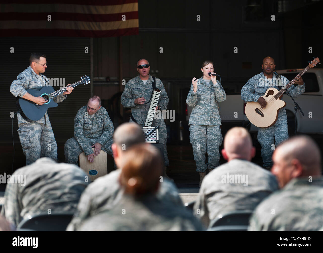 The U.S. Air Forces Central Band 'Top Flight' performs at the Transit Center at Manas, Kyrgyzstan, Sept. 22, 2012. This performance, which was held in the 376th Expeditionary Logistics Readiness Squadron facility, was played in conjunction with a BBQ to improve morale. Stock Photo
