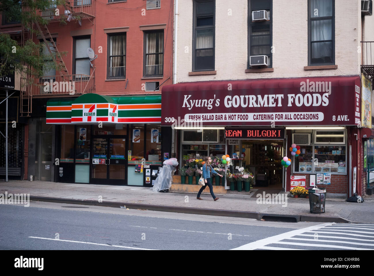 A 7-Eleven store next to a Korean owned deli is seen in the Chelsea neighborhood of New York Stock Photo