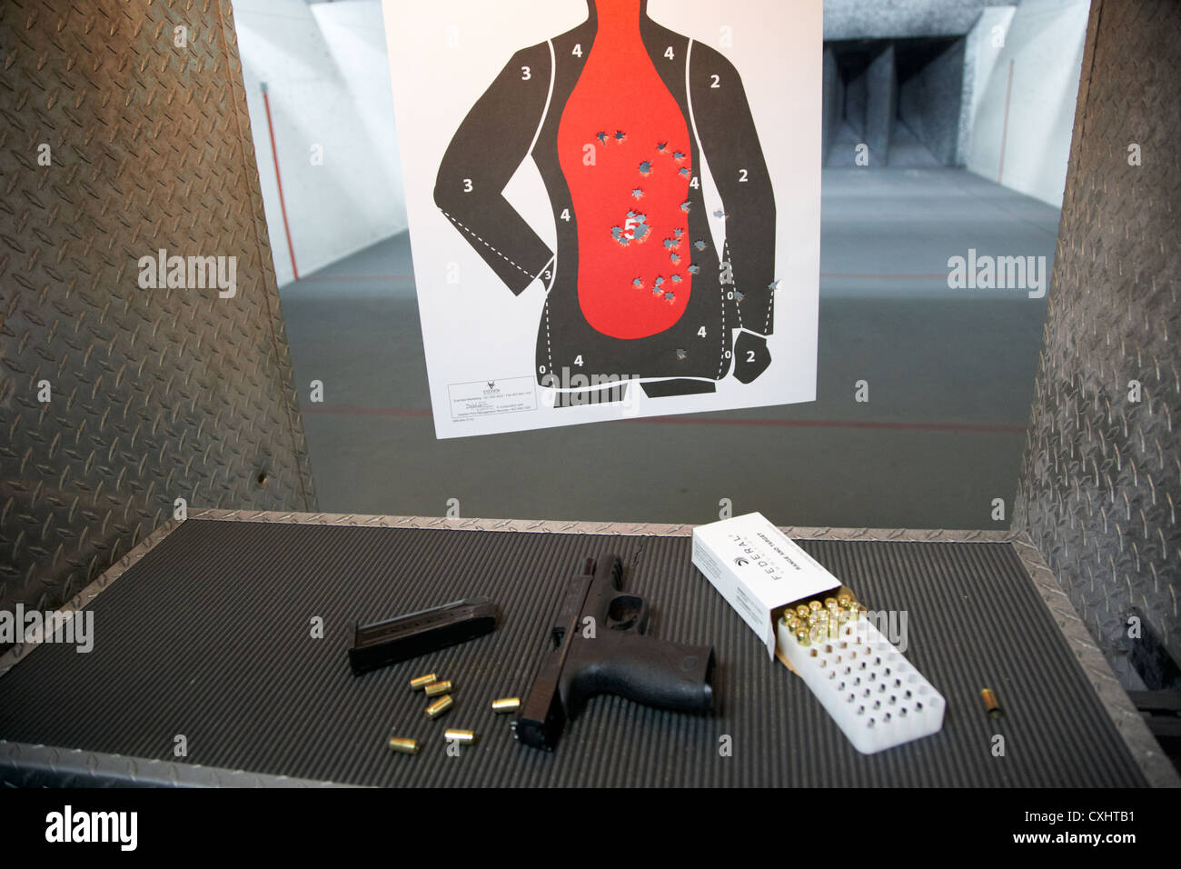 smith and wesson 9mm handgun with ammunition and holes in a human shaped target during firearms training at a gun range in florida usa concealed carry Stock Photo