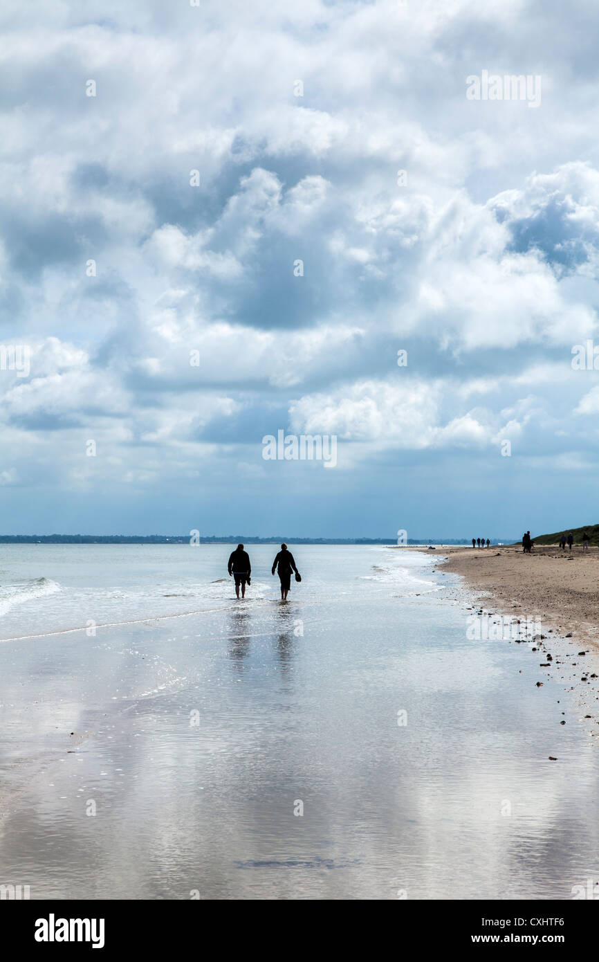 People walking along Utah Beach, Sainte-Marie-du-Mont, Normandy, France Stock Photo