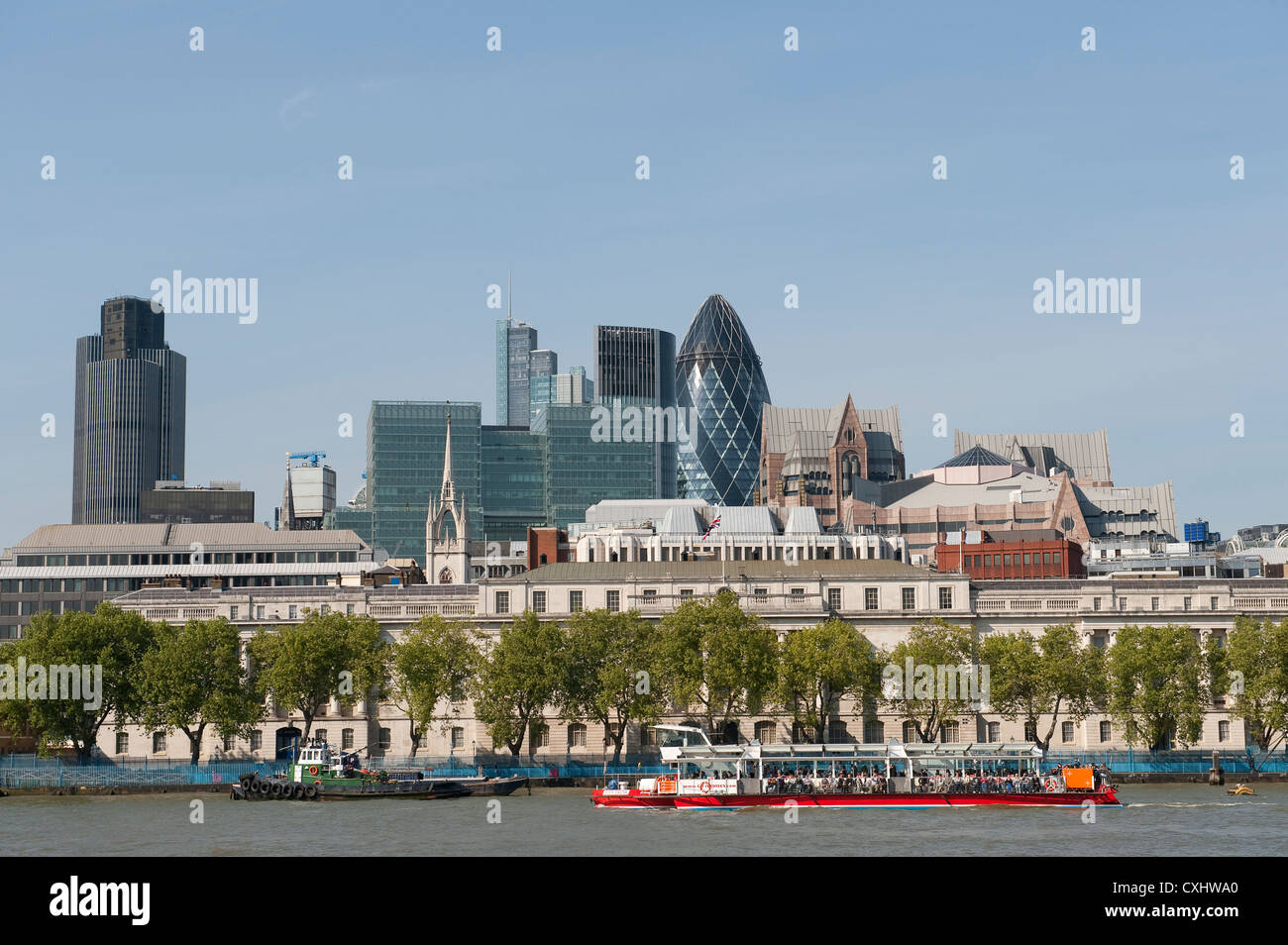 Beautiful view of boats on the River Thames with tall buildings of the ...