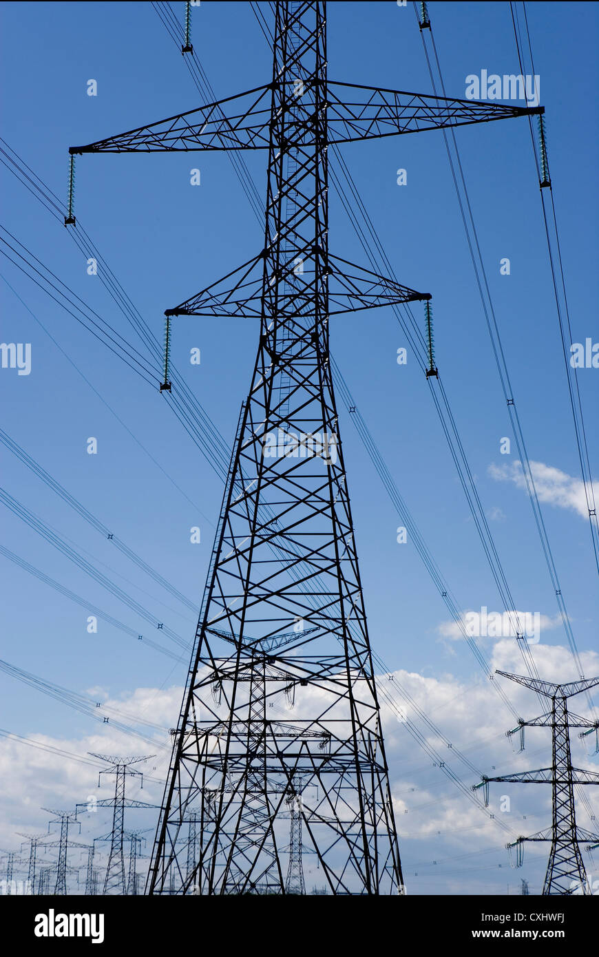 Dramatic view of giant hydro towers against blue sky Stock Photo