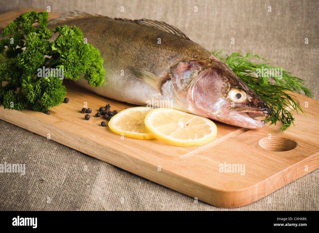 Pike perch on a wooden kitchen board Stock Photo