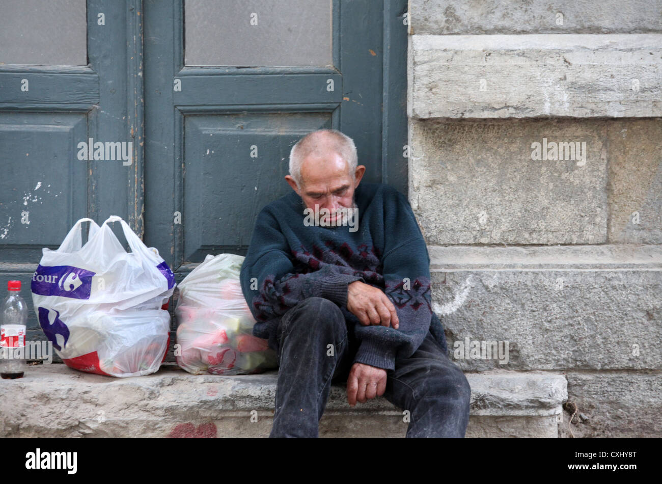 Drunk Man Asleep on the Street in Albania Stock Photo