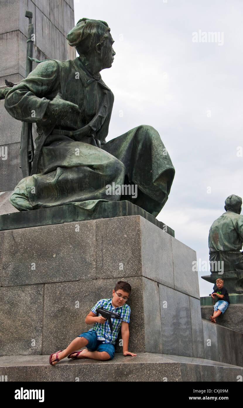 Boys with toy guns playing on war memorial at St. Vladimir Cathedral in Sevastopol, Ukraine. Stock Photo