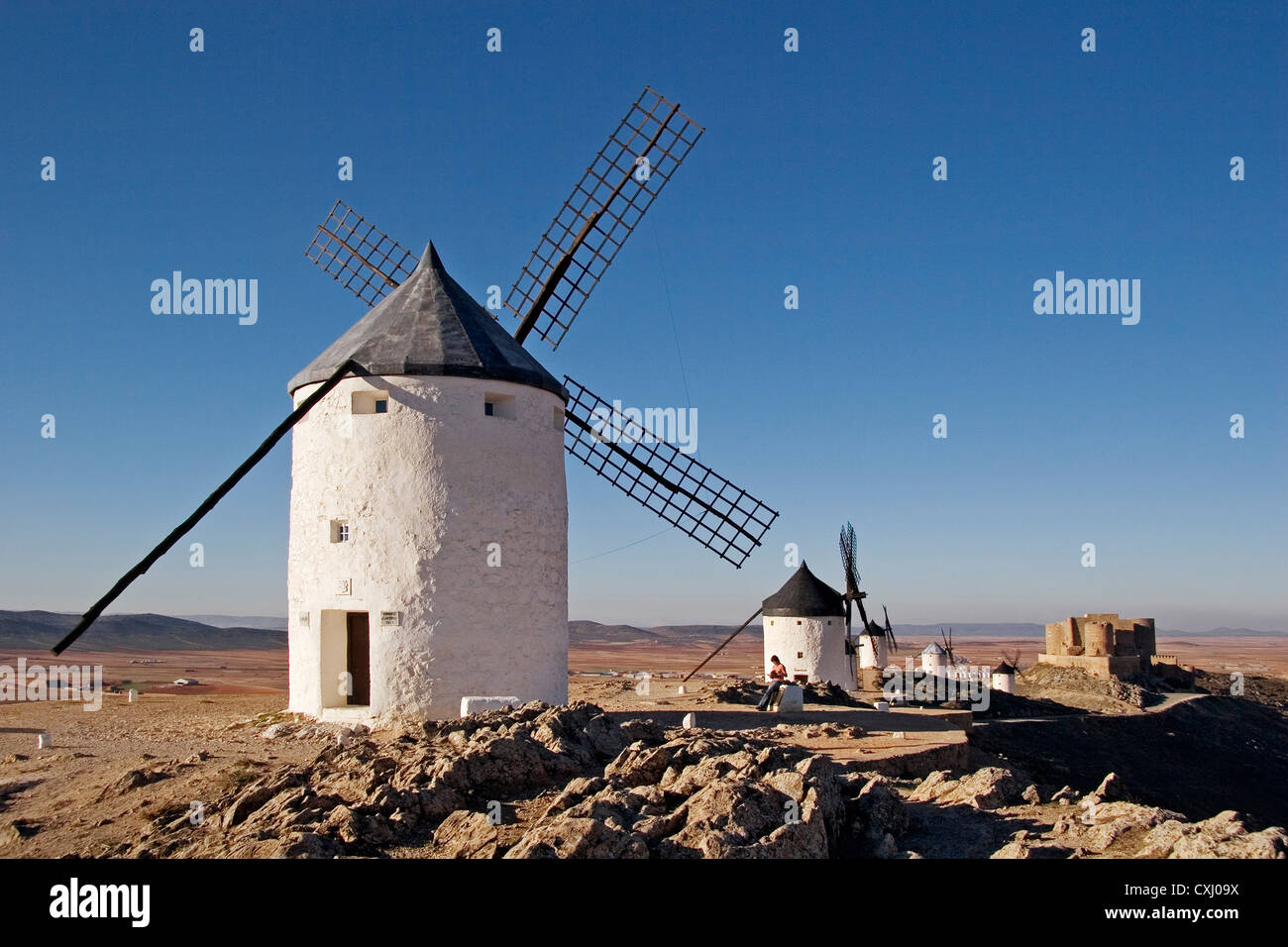 windmills and castle Consuegra Toledo Castilla La Mancha Spain molinos de viento y castillo en consuegra españa Stock Photo