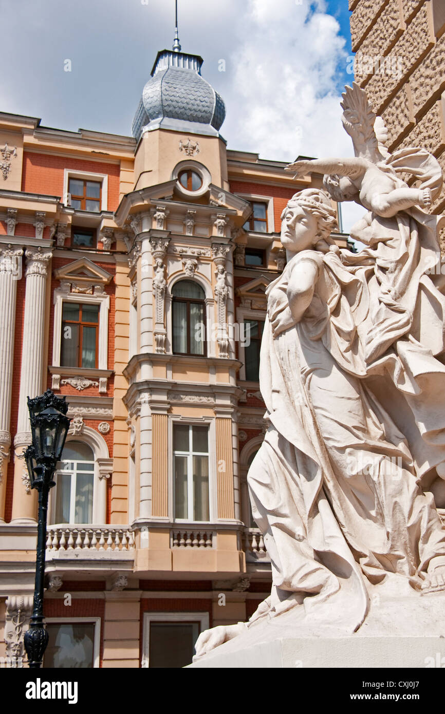 Statuary at entrance of Odessa National Academic Theater of Opera and Ballet with nearby facade of classic architecture. Stock Photo