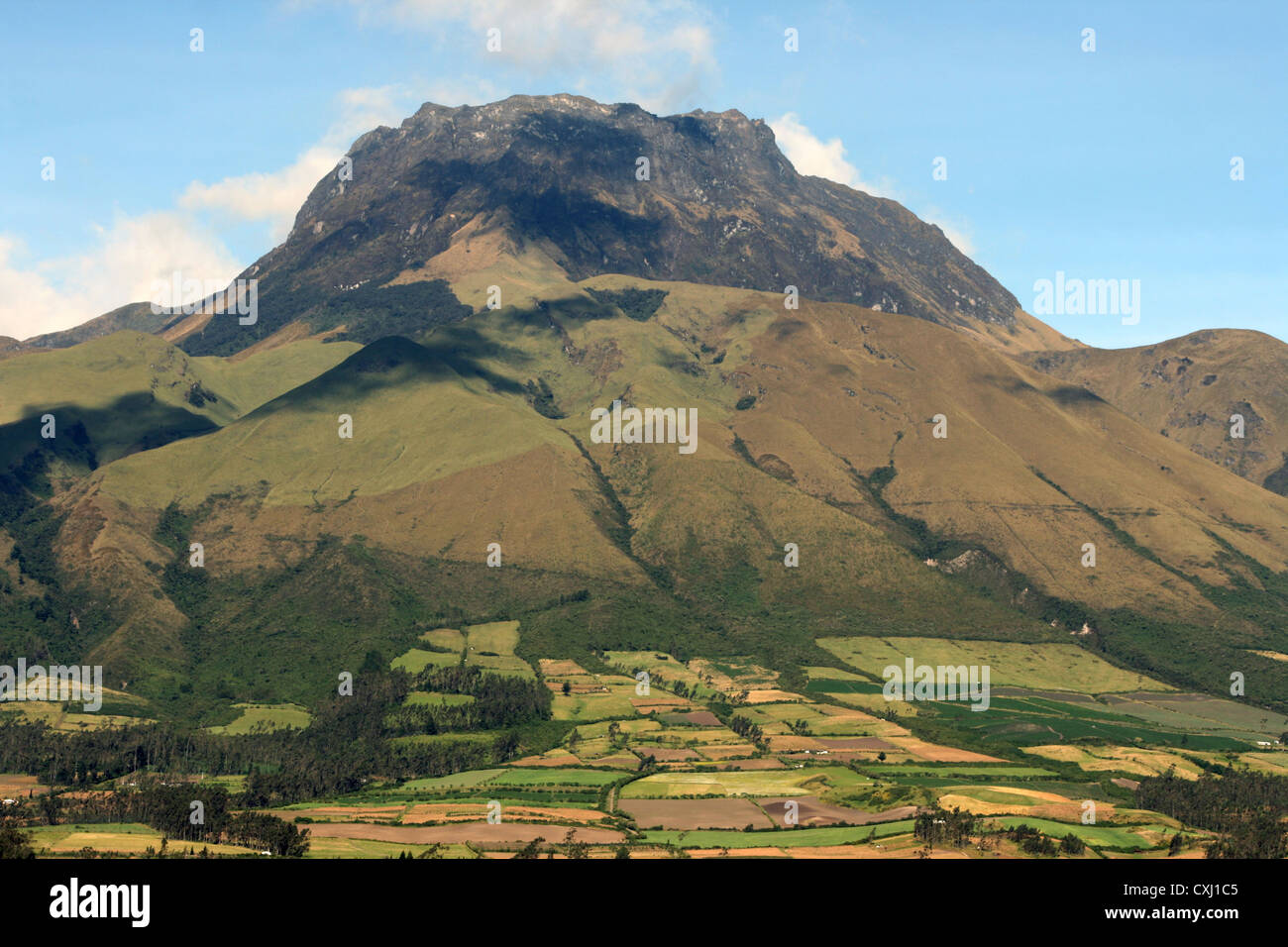The dormant volcano, Mount Imbabura, with fields climbing its flanks near Cotacachi, Ecuador Stock Photo