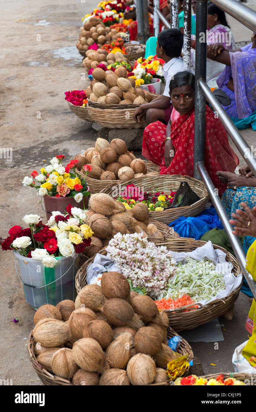 Indian women selling flowers and coconuts on a street in Puttaparthi, Andhra Pradesh, India Stock Photo