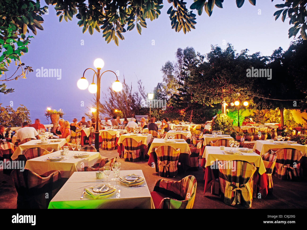 dinner at dusk in a restaurant next to the Mediterranean Sea nerja malaga costa del sol Andalusia Spain restaurante andalucia Stock Photo