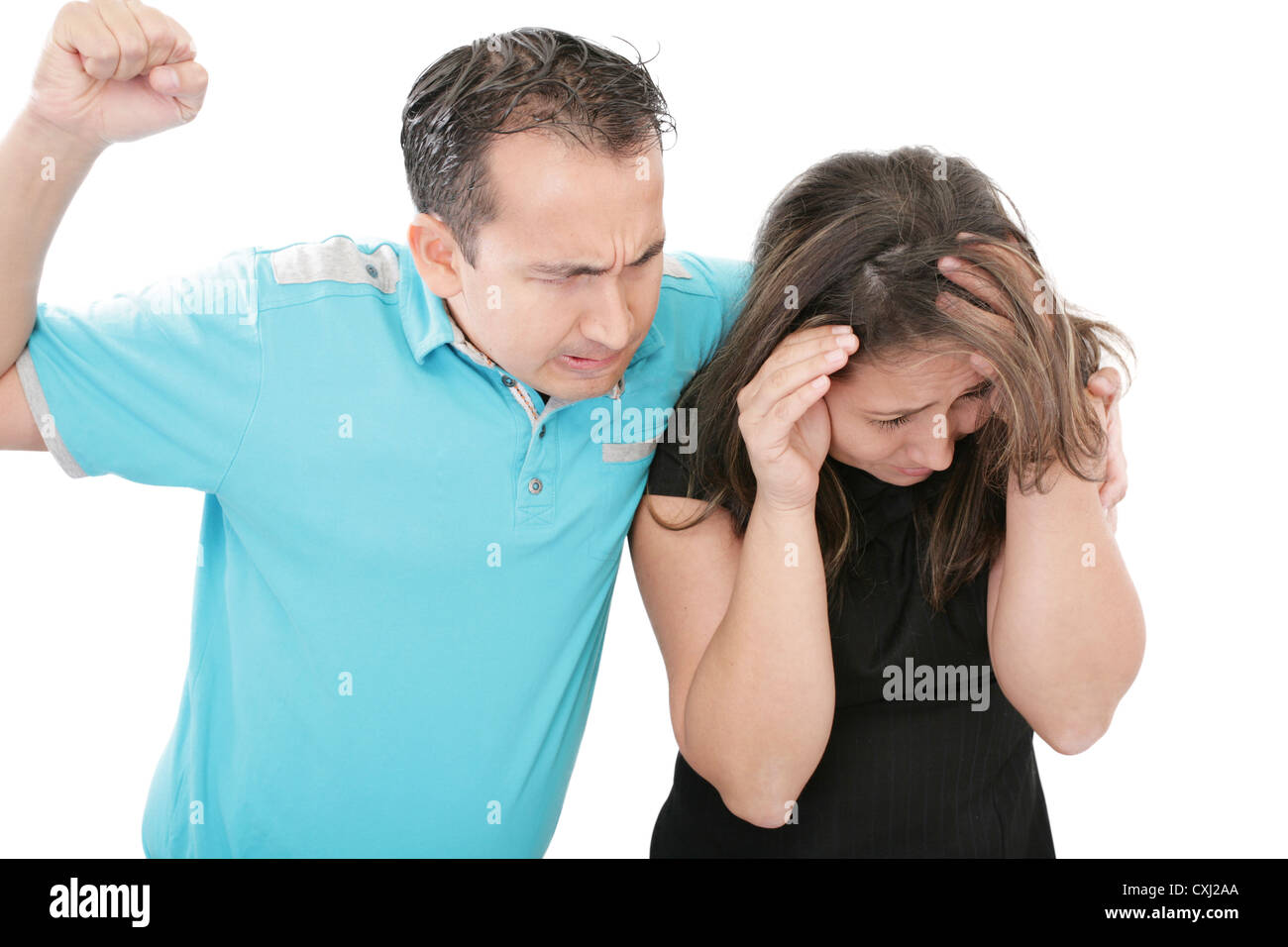 Terrified abused woman trying to stop the attack and defend herself, Stock Photo