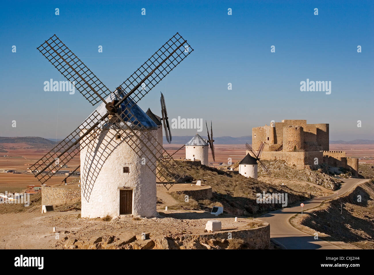 windmills and castle Consuegra Toledo Castilla La Mancha Spain molinos de viento y castillo en consuegra españa Stock Photo