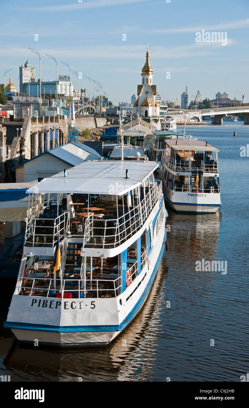 Tour boats on Dnieper riverfront near St. Nicholas Orthodox Christian Church in Kiev Stock Photo