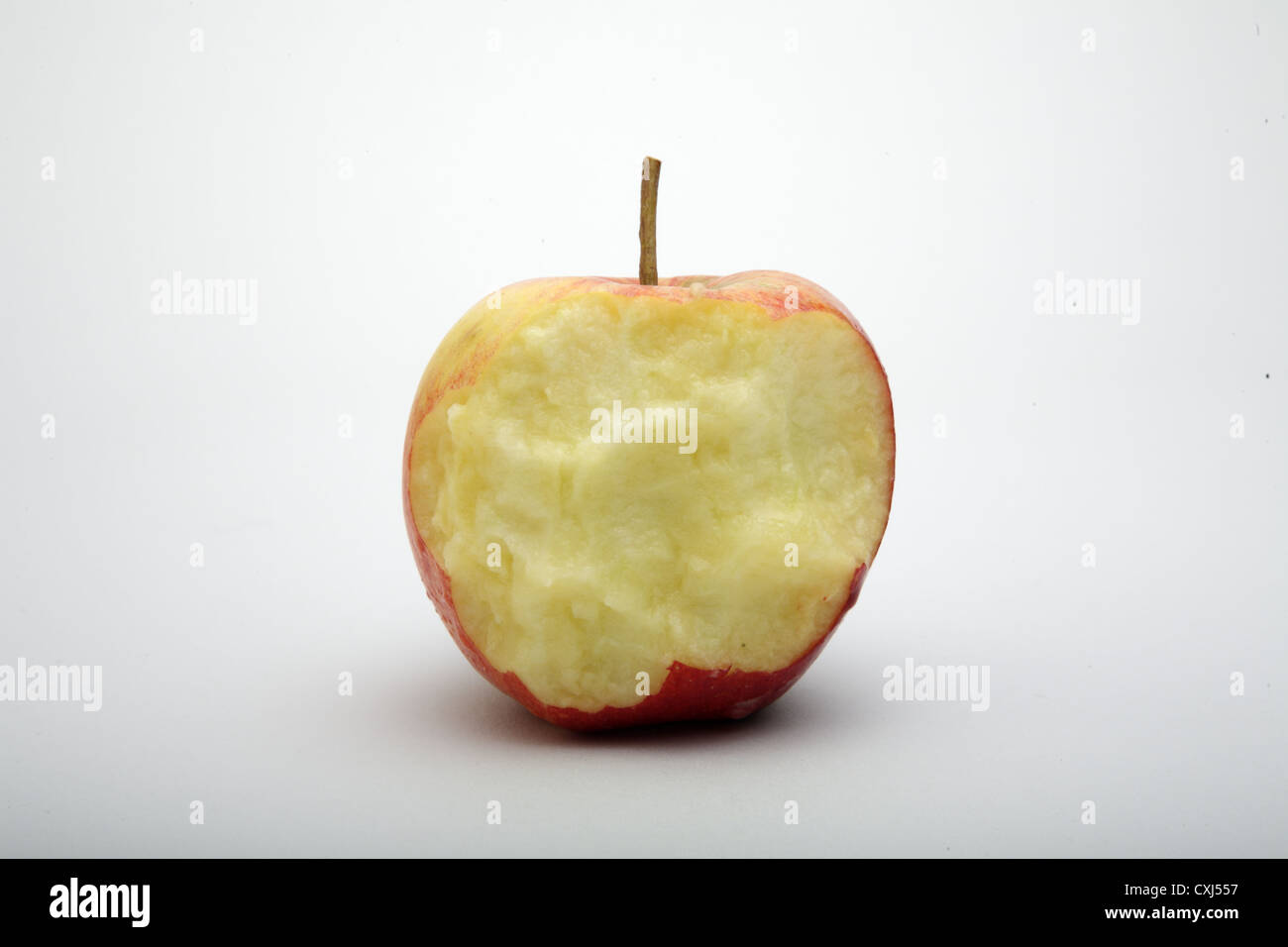 Half eaten apple on a white background. Stock Photo