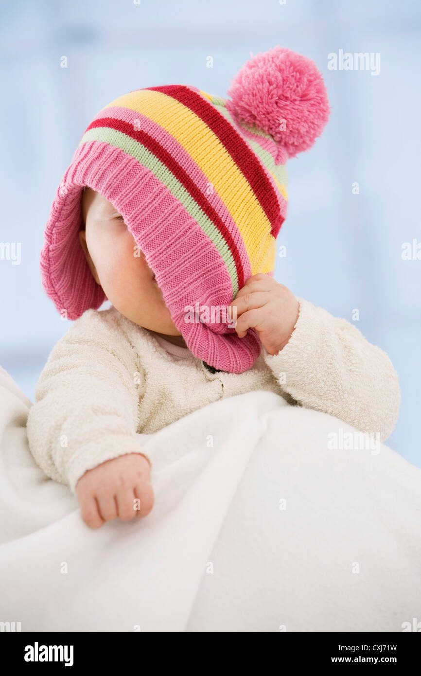 Baby girl covering face with hat, close up Stock Photo Alamy