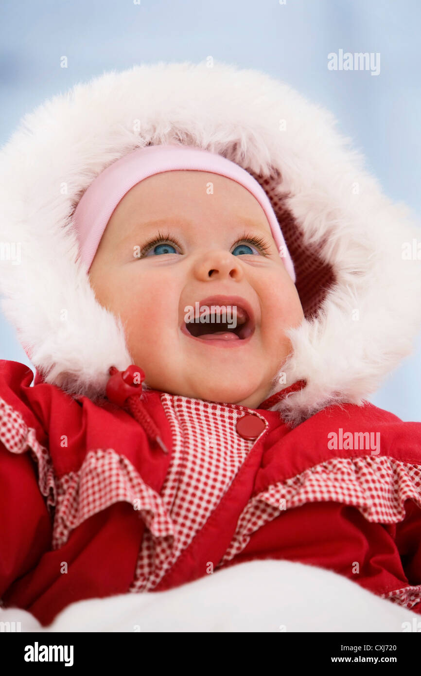 Baby girl in snow suit, smiling Stock Photo Alamy