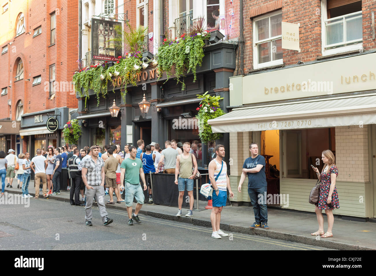 People standing outside the Comptons bar in Soho, London, UK Stock Photo