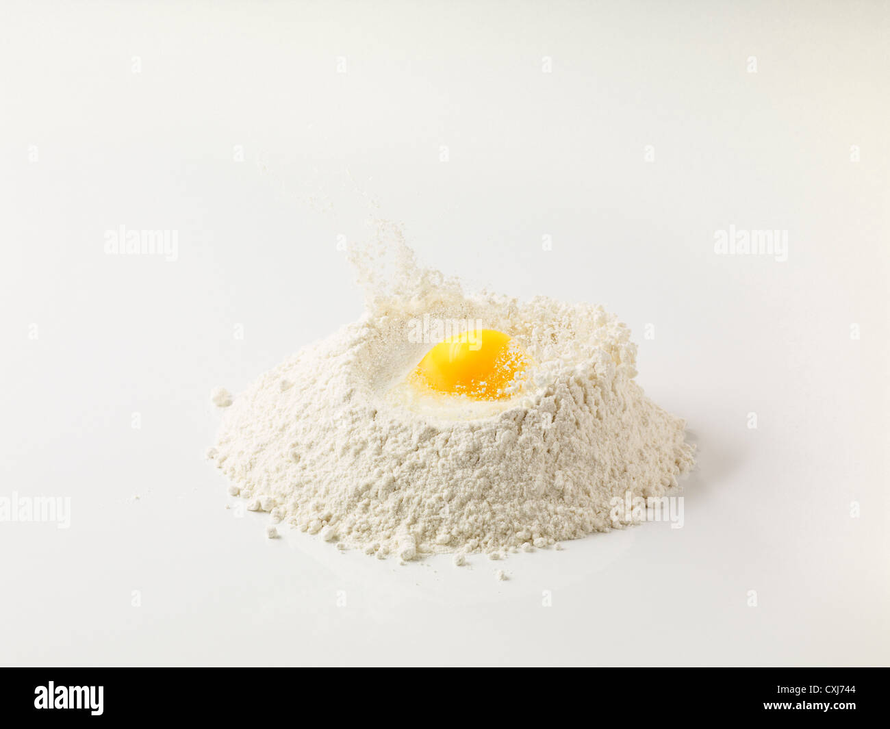 Egg yolk in flour on white background Stock Photo Alamy