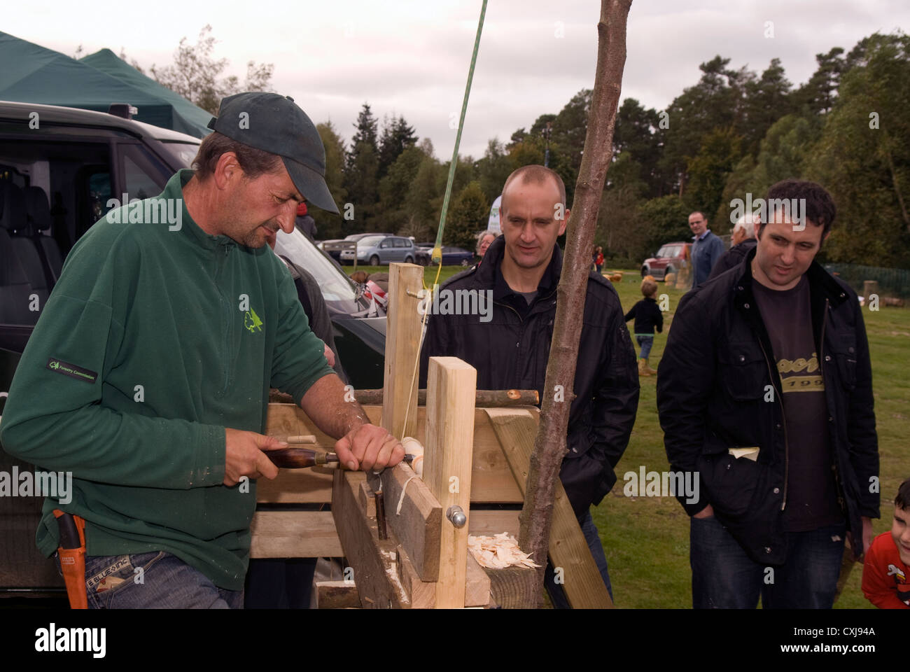 People watching a demonstration of woodcraft skills at a Forestry