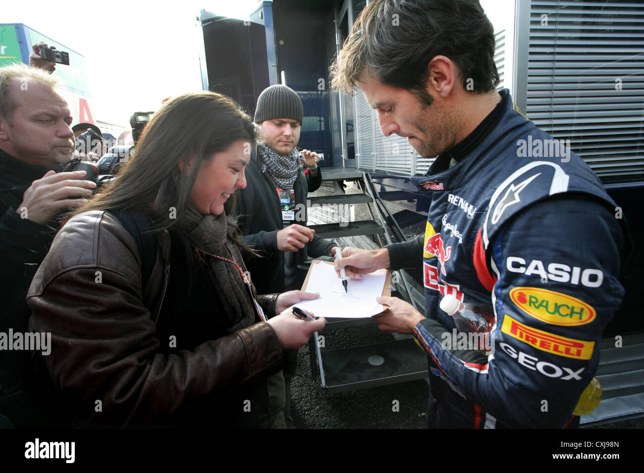 Formula One driver Mark Webber signing autographs for fans at Montmelo motor racing circuit, Barcelona, Spain Stock Photo