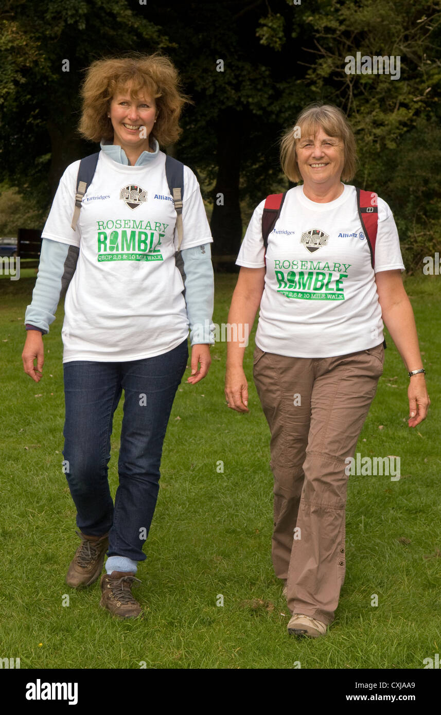 Two women taking part in a walk for charity, Queen Elizabeth Country Park, near Petersfield, Hampshire, UK. Stock Photo