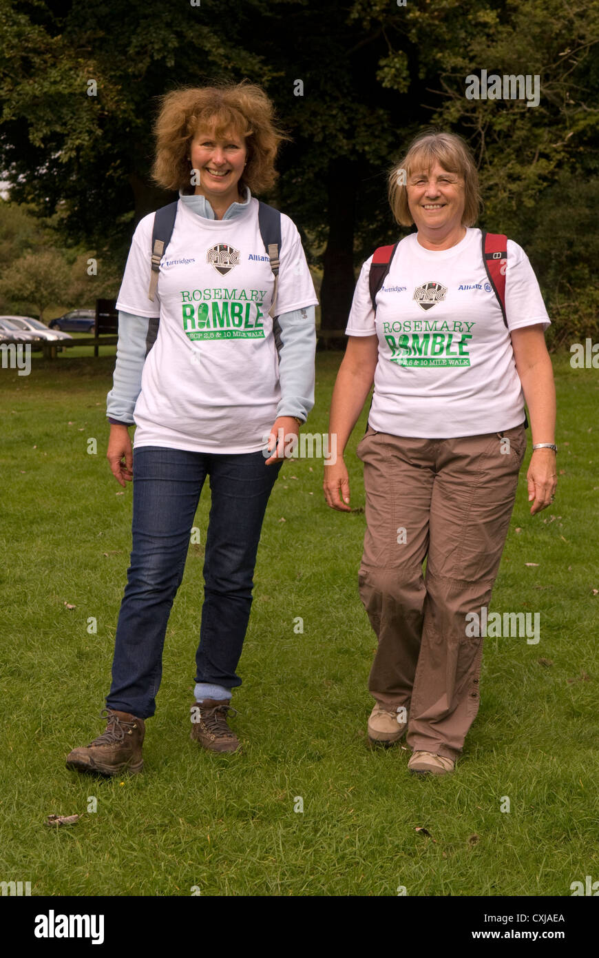 Two women taking part in a walk for charity, Queen Elizabeth Country Park, near Petersfield, Hampshire, UK. Stock Photo
