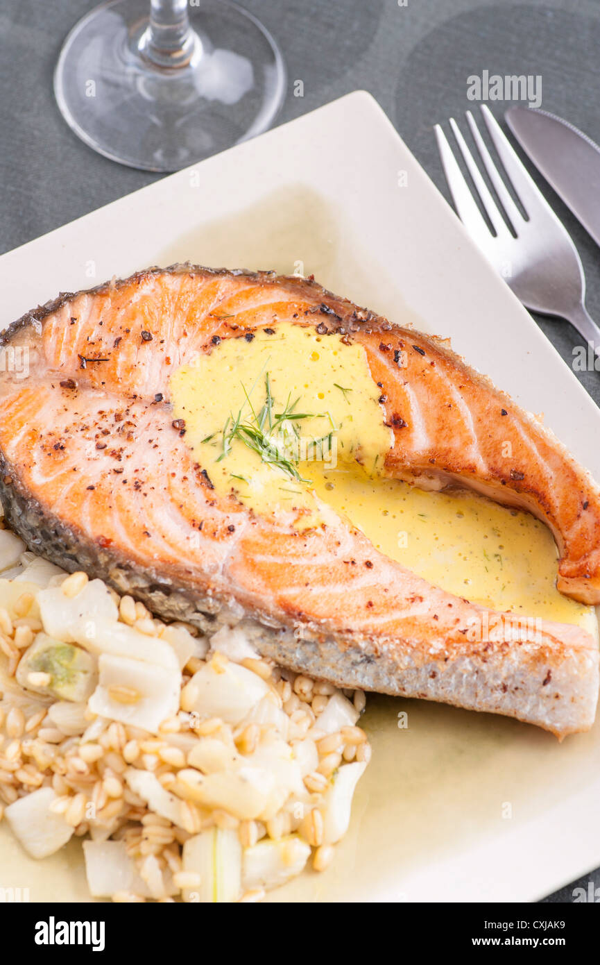 Seafood meal with fried salmon, bulgur, fennel and aioli Stock Photo
