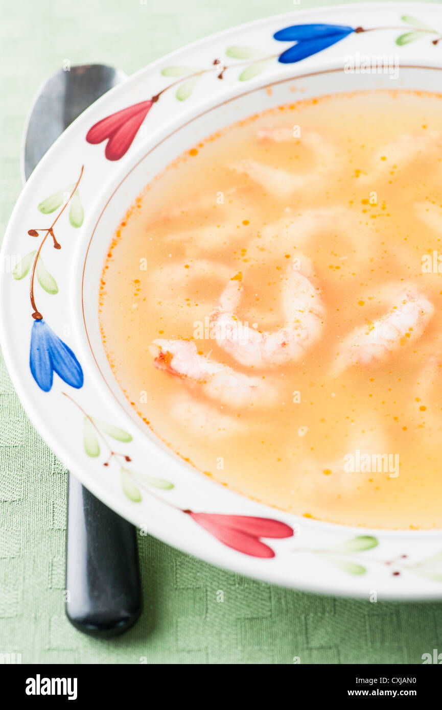 Bowl of warm soup with prawns and broth Stock Photo