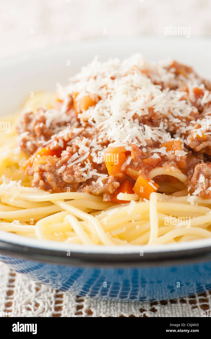 Closeup of serving of pasta bolognaise with grated parmesan cheese on top. Stock Photo
