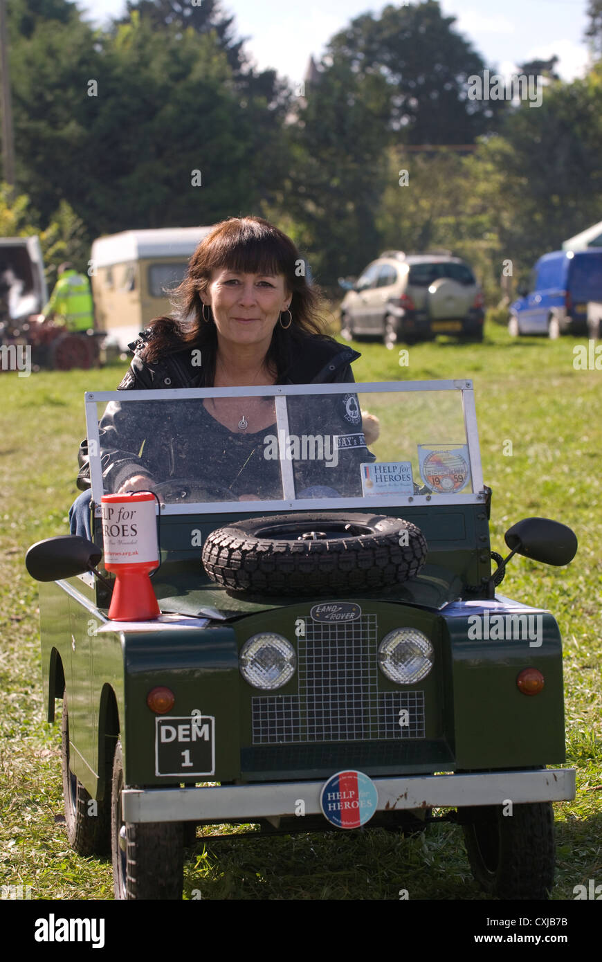 Woman driving a Toylander (based on a 1950s Landrover design) at a steam & vintage gathering to raise money for Help for Heroes Stock Photo