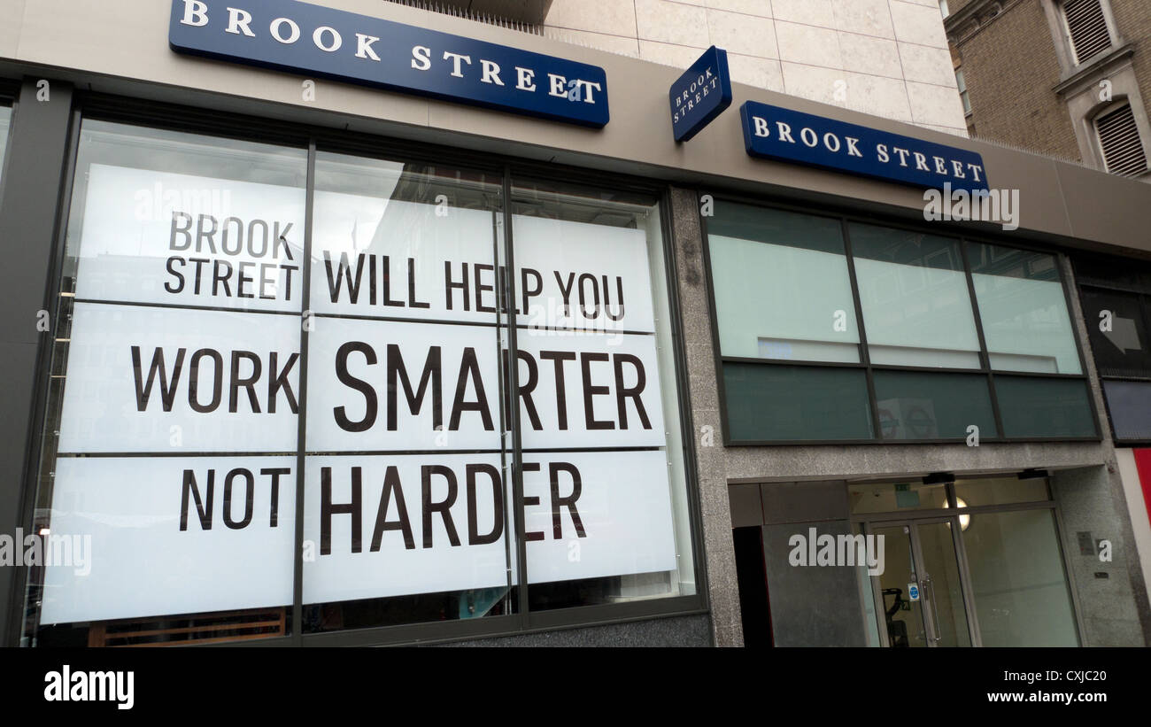 Employment Bureau Brook Street Will Help You Work Smarter Not Harder poster and signs in London England UK Stock Photo