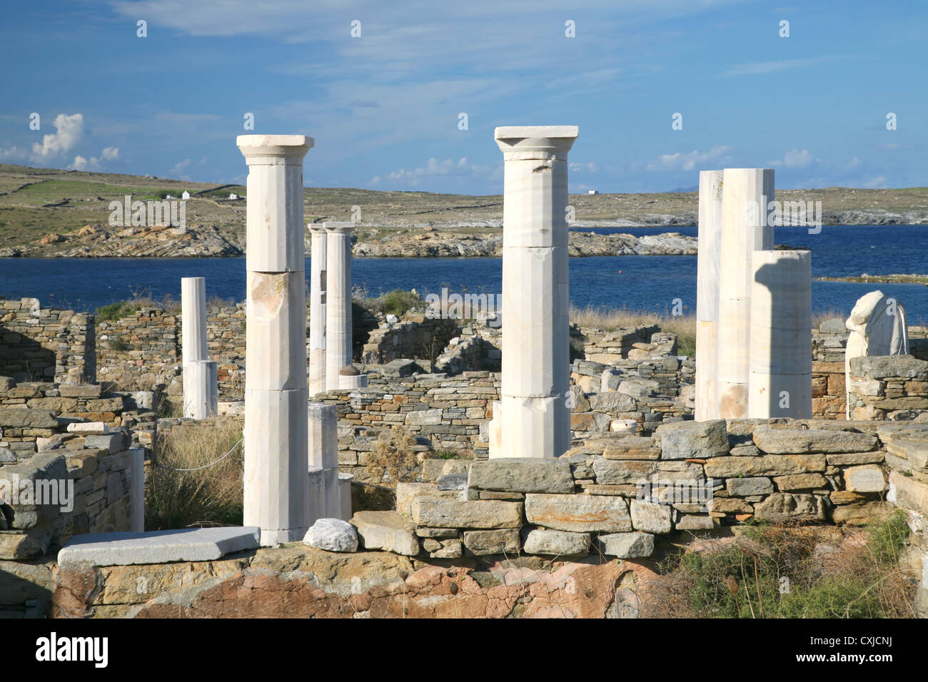 View overlooking 'Cleopatra's House' and the ruins of Delos towards the shore  the Greek island of Delos. Stock Photo