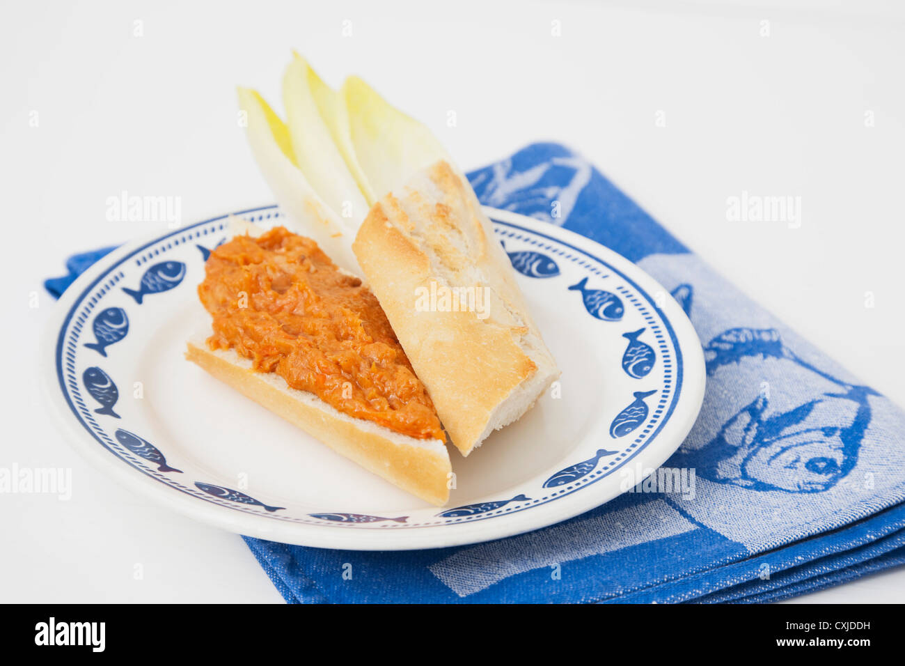 Baguette sandwich with tuna and tomato spread on plate Stock Photo