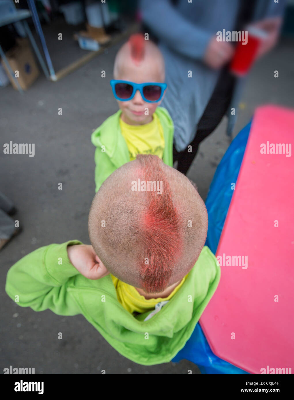 Twin boys with mohawk hairstyleYoung twins at a summer festival showing off their red mohawks, Akureyri,  Iceland Stock Photo