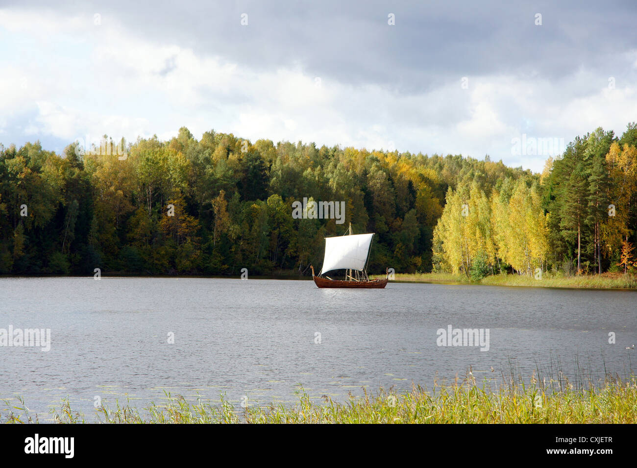 Sailing boat on a background of a forest Stock Photo