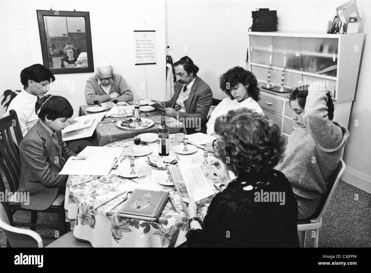 Family taking part in feast of the Passover service in a Jewish home 1980s Stock Photo