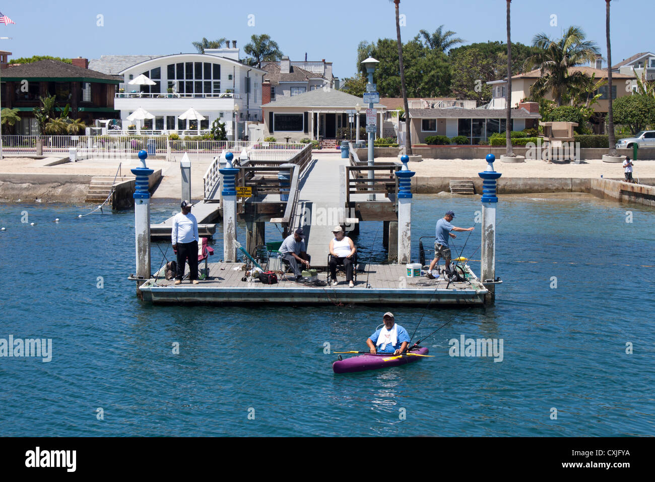 Fishing off a dock and kayak in Newport Bay, California Stock Photo Alamy