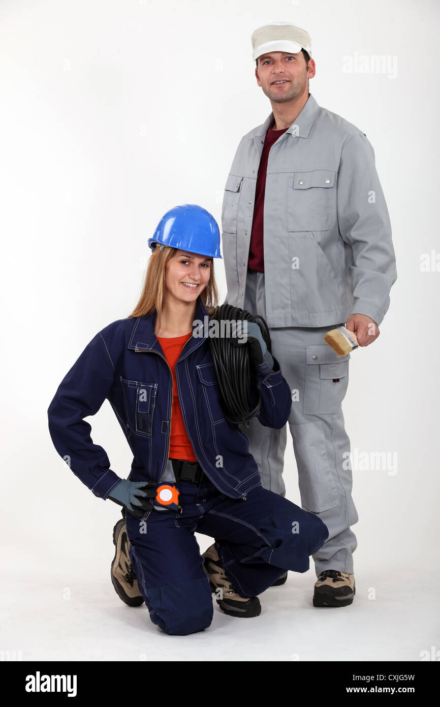 Electrician kneeling by painter Stock Photo Alamy