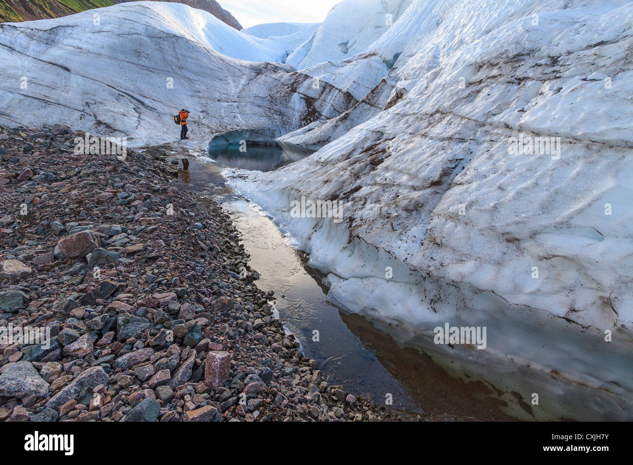 Man photographs toe of Brother John Glacier at the old Inuit village