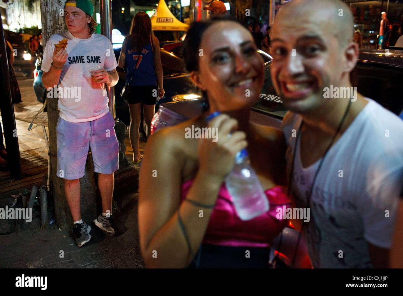 Foreign tourists on a street at night in Kuta, Bali, indonesia. Stock Photo