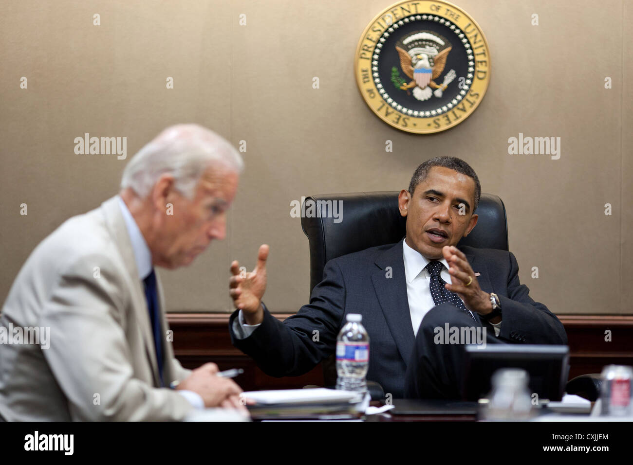 US President Barack Obama and Vice President Joe Biden meet with National Security Staff June 20, 2011 in the Situation Room of the White House. Stock Photo
